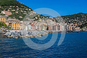 Camogli marina harbor, boats and typical colorful houses. Travel destination Ligury, Italy.