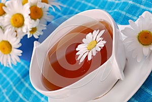 Camomile tea in white cup