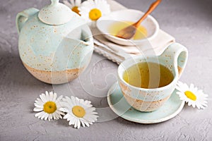 Camomille tea in handmade ceramic cup photo