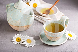 Camomille tea in handmade ceramic cup