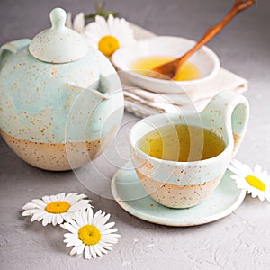 Camomille tea in handmade ceramic cup