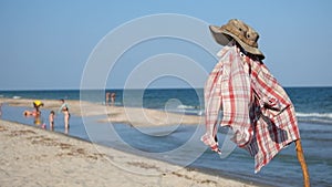 Camouflage hat and checkered shirt on a pole