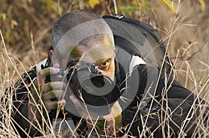 Camouflaged war photojournalist.