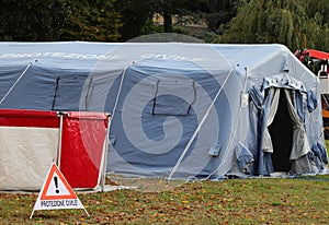 Camp equipped with a tent and warning signs and the text in Ital photo