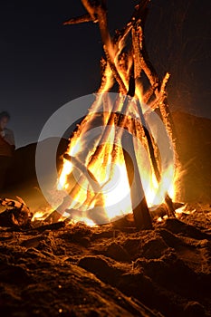 Camp fire on the beach at night