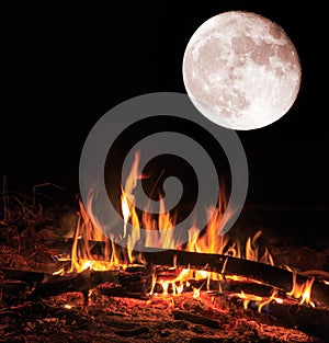 Camp fire and big moon at night