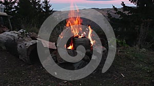 Camp fire with mountain landscape in background