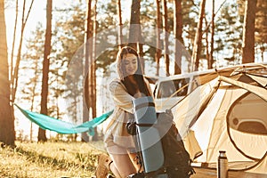 In the camp. Woman is traveling alone in the forest at daytime at summer