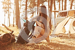 In the camp. Woman is traveling alone in the forest at daytime at summer