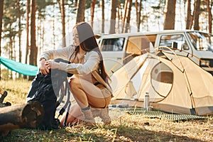 In the camp. Woman is traveling alone in the forest at daytime at summer