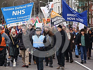 Campaigners march through Brighton, UK in protest against the planned cuts to public sector services. The march was organised by B