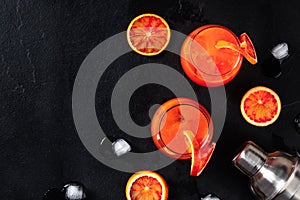 Campari orange cocktails, shot from the top on a black background