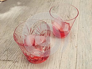 Campari served in two crystal glass with ice cubes