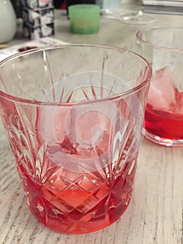 Campari served in two crystal glass with ice cubes