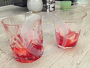 Campari served in two crystal glass with ice cubes