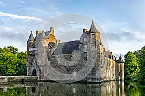 Historic Chateau Trecesson castle in the Broceliande Forest with reflections in the pond