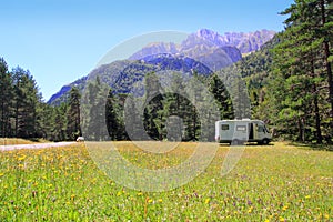 Camper autocaravan meadow in Pyrenees mountain photo