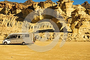 Camper car at rock formations Bolnuevo, Spain photo
