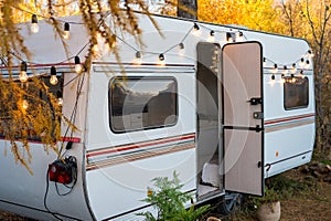 Camper or mobile home in the countryside. Cozy van in the autumn forest.