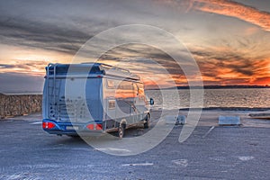 Camper parked on the beach in HDR