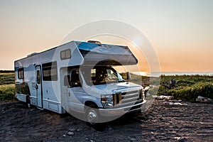 Camper RV truck parked at the Cape Breton Island Coast line Sunset cliff scenic Cabot Trail Nova Scotia Hghlands Canada