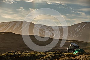 Camper and a tent in a splendid landscape