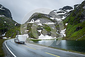 Camper traveling at scenic norwegian road in the mountains.