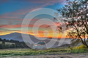 Camper van camping with sunrise