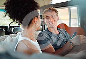 Camper, van and couple relax while travel, happy, talking and bonding in their vehicle together. Love, freedom and