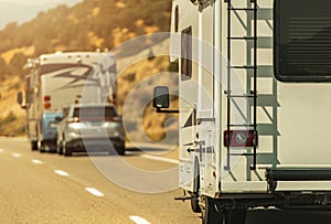 Camper Van and Diesel Pusher Motorhome on a Highway