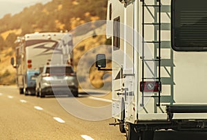 Camper Van and Diesel Pusher Motorhome on a Highway photo