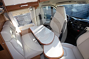 Camper van interior with white table wooden in modern new motor home for vanlife