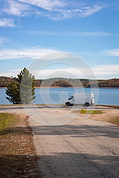 Camper van living van life near a lake reservoir of a dam in Sabugal, Portugal