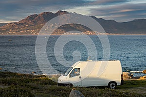 Camper van motorhome with solar panels view on a sea landscape with mountains living van life in Galiza, Spain photo