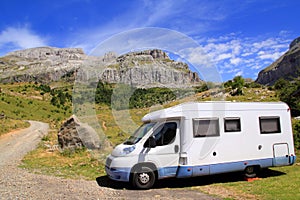 Camper van in mountains blue sky photo