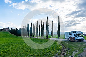 Camper van parked near cypresses  in tuscany