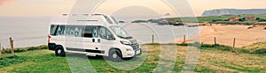 Camper van parked next to beach at summer