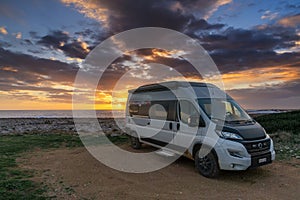 camper van parked on the shores of the Gulf of Taranto in Apulia at sunset