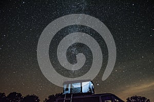 Camper van vith roof tent during night in Bebrza national park.