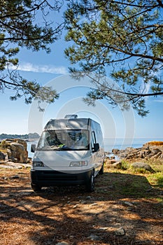 Camper van on a wild beach in Arousa island living van life in Galicia, Spain