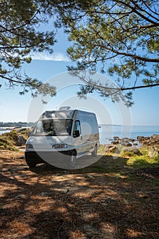 Camper van on a wild beach in Arousa island living van life in Galicia, Spain