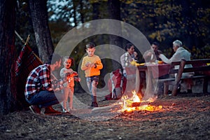 Campers with children enjoying in wood