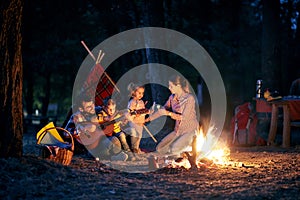 Campers family on evening in forest