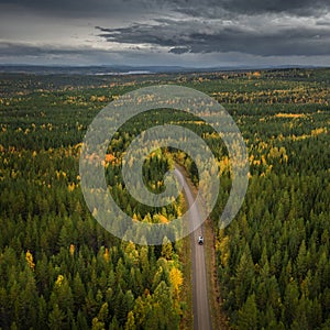 Campervan driving in landscape of Wildernes Road in Lapland in Sweden from above photo