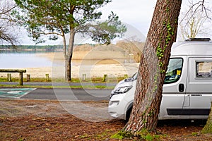 Campervan by lake sea in summer concept of vanlife in french coast in Sanguinet city