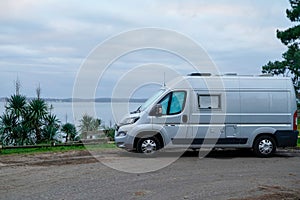 Campervan rv parked on seaside in winter sunrise vanlife day in french coast in cap ferret village france