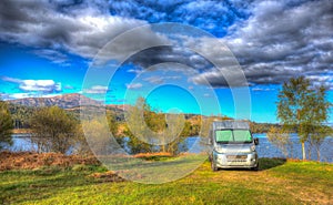 Campervan wildcamping in Scotland by Scottish Loch Garry UK with mountains colourful HDR