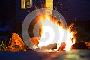 A campfire burning bright in the dark night