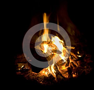Campfire burning fire ash flames and coals closeup photo