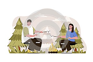 Campfire concept. Couple fries marshmallows at campsite in forest situation. Outdoor activity, tourism, camping people scene.